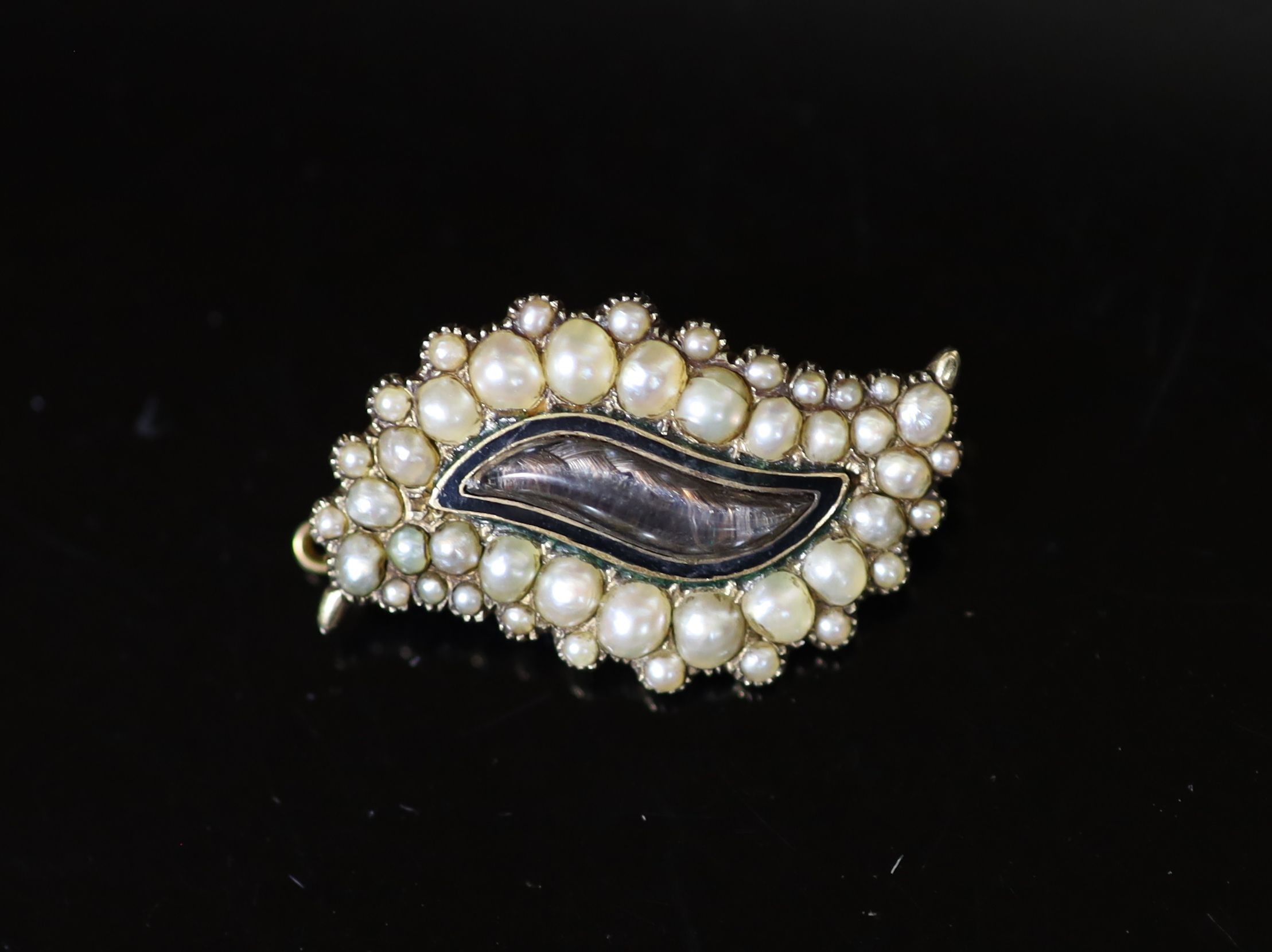 A George IV gold, graduated split pearl and black enamel leaf shaped mourning brooch